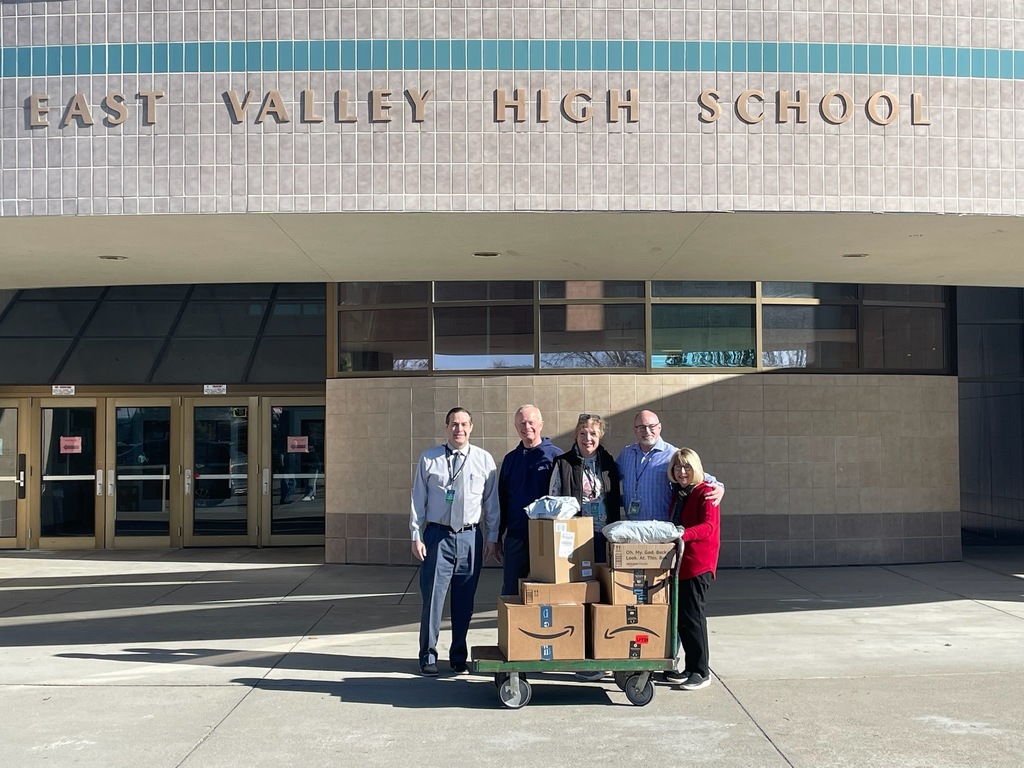 Group photo posing with donations outside of EVHS