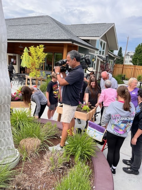 Students and senior citizens planting flowers